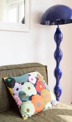 a pillow sitting on a couch next to a lamp at Quiet Elegance in Sofia Center in Sofia