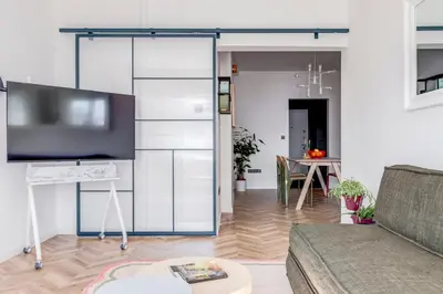 a living room with a couch and a flat screen tv at Quiet Elegance in Sofia Center in Sofia