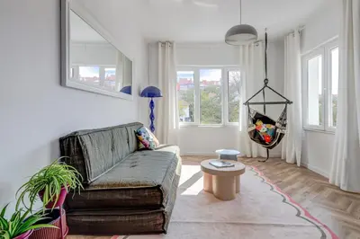 a living room with a couch and a table at Quiet Elegance in Sofia Center in Sofia