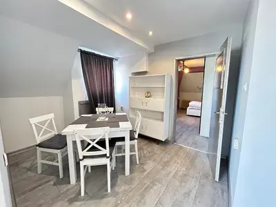 a dining room with a white table and chairs at River Nest in Plovdiv