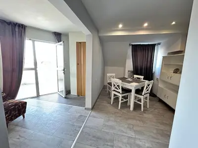 a living room with a table and chairs in a room at River Nest in Plovdiv