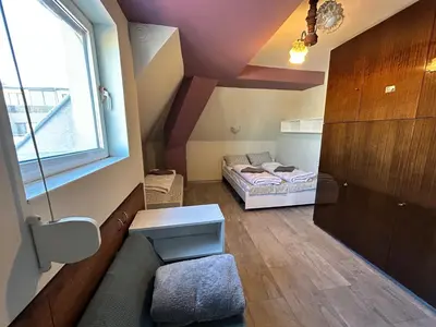 a small room with a bed and a window at River Nest in Plovdiv
