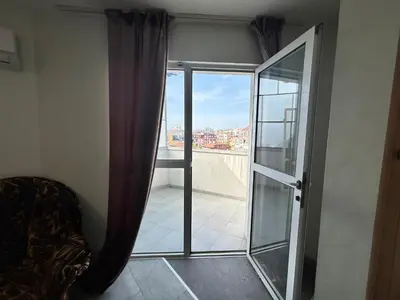 a room with a glass door leading to a balcony at River Nest in Plovdiv