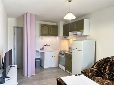 a kitchen with green cabinets and a white refrigerator at River Nest in Plovdiv