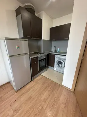 a kitchen with a refrigerator and a washing machine at The Leverage in Sofia
