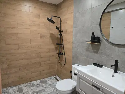 a bathroom with a shower and a toilet and a sink at KS Gondola point apartment in Bansko