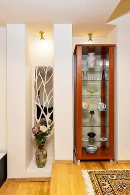 a room with a glass cabinet with a vase in it at Stancho's House 3BR apartment close to OLD TOWN & KAPANA district in Plovdiv