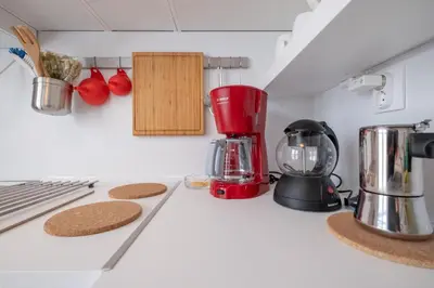 a red blender sitting on top of a kitchen counter at LZ Spacious One Bedroom Apartment in Top Centre by Flat Mаnager in Sofia