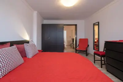 a bedroom with a red bed with a red blanket at LZ Spacious One Bedroom Apartment in Top Centre by Flat Mаnager in Sofia
