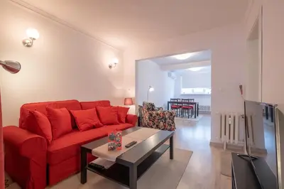a living room with a red couch and a table at LZ Spacious One Bedroom Apartment in Top Centre by Flat Mаnager in Sofia