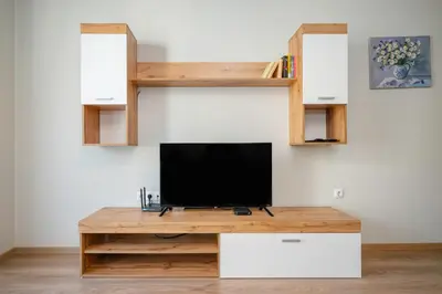 a living room with a tv on a white wall at 1BD Apartment in Sofia City Center by Flat Mаnаger in Sofia