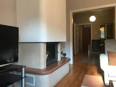 a living room with a fireplace with a couch and a tv at Beautiful Business Apartment - Ivan Denkoglu Street by Flat Mаnager in Sofia
