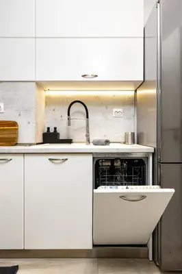 a white kitchen with a sink and a dishwasher at City Castle apartment 3BR in central Plovdiv in Plovdiv