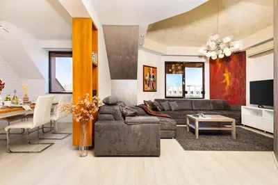 a living room with a couch and a table at City Castle apartment 3BR in central Plovdiv in Plovdiv