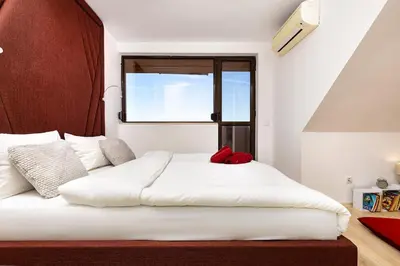 a white bed in a room with a window at City Castle apartment 3BR in central Plovdiv in Plovdiv