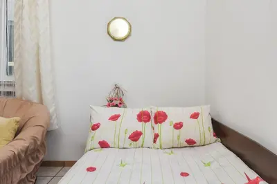 a bed with red poppy pillows in a room at Historical Lion's Bridge 1-Bedroom Apartment by Flat Mаnager in Sofia