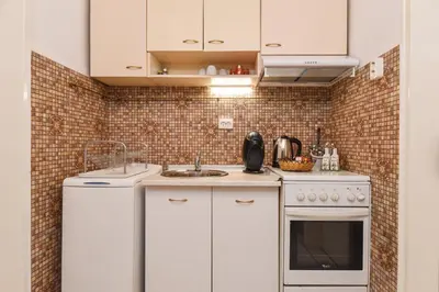a white kitchen with a sink and a stove at Historical Lion's Bridge 1-Bedroom Apartment by Flat Mаnager in Sofia