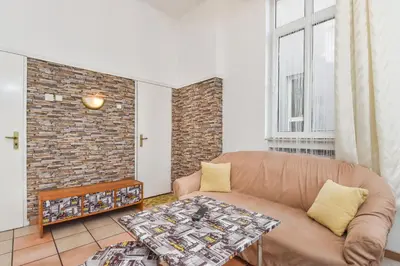 a living room with a couch and a brick wall at Historical Lion's Bridge 1-Bedroom Apartment by Flat Mаnager in Sofia