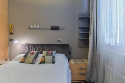 a bedroom with a bed with two pillows on it at Stylish One-bedroom Flat with Amazing City View by Flat Mаnаger in Sofia