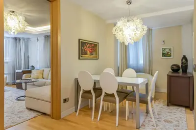 a dining room with a table and chairs at Stylish One-bedroom Flat with Amazing City View by Flat Mаnаger in Sofia