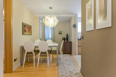 a dining room with a white table and chairs at Stylish One-bedroom Flat with Amazing City View by Flat Mаnаger in Sofia