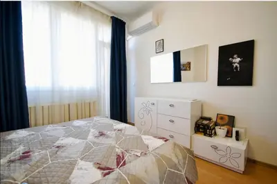 a bedroom with a bed and a dresser and a window at Къща за гости,, Зафир,, in Sofia