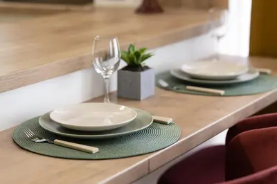two plates and a wine glass on a table at Domus Magnolia Studio In The Top Center in Plovdiv