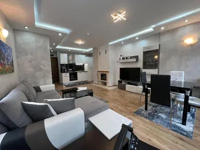 a large living room with a couch and a table at Tulip Apartment High-End, Grand Resort Pamporovo in Pamporovo