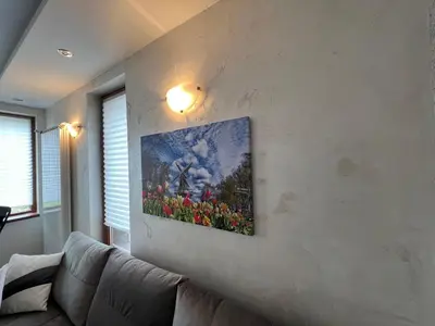 a painting on the wall of a living room with a couch at Tulip Apartment High-End, Grand Resort Pamporovo in Pamporovo