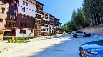 a car parked on a street next to a building at Tulip Apartment High-End, Grand Resort Pamporovo in Pamporovo