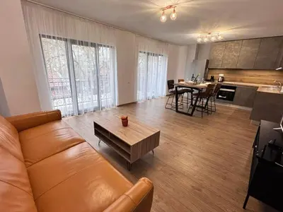a living room with a couch and a table at Spacious sunny flat with 2 bedrooms in the heart of Plovdiv in Plovdiv