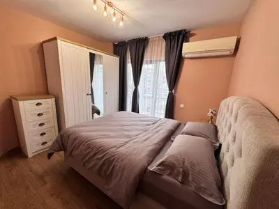 a bedroom with a large bed and a window at Spacious sunny flat with 2 bedrooms in the heart of Plovdiv in Plovdiv