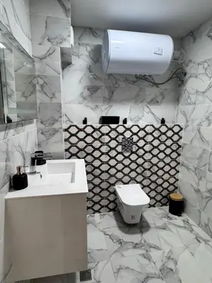 a bathroom with a white sink and a toilet at Spacious sunny flat with 2 bedrooms in the heart of Plovdiv in Plovdiv