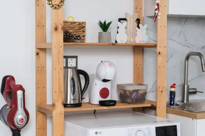 a kitchen counter with a wooden shelf above a stove at Apartment Velik in Sandanski