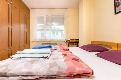 a bedroom with two beds and a window at Quiet apartment near the center by Flat Mаnager in Plovdiv