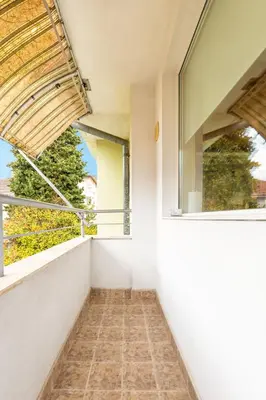 an empty balcony with windows and a tiled floor at Quiet apartment near the center by Flat Mаnager in Plovdiv