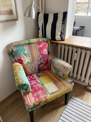 a colorful chair sitting in a living room at Nice and cozy in Sofia