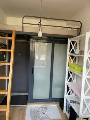 a room with a bunk bed with a door and shelves at Nice and cozy in Sofia