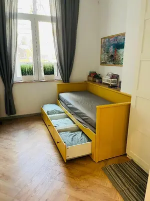 a bedroom with a bunk bed in front of a window at Casa Tiempo in Sofia