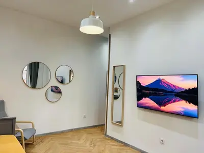 a living room with a tv on a wall at Casa Tiempo in Sofia