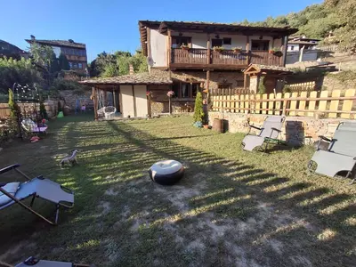a house with a ball on the grass in the yard at Капсъзовата къща in Leshten