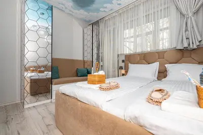 a bedroom with a large bed with two baskets on it at ElenartLux - Baby Cot - Pets Allowed - Free Parking & Fast Wi-Fi in Plovdiv