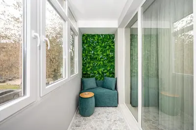 a room with a blue chair and a green wall at ElenartLux - Baby Cot - Pets Allowed - Free Parking & Fast Wi-Fi in Plovdiv