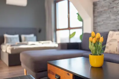 a living room with a vase of flowers on a table at Studio Talisman V in Sofia