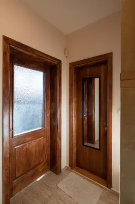 a hallway with a wooden door and a window at Studio Talisman V in Sofia