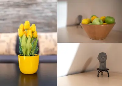 a vase with yellow flowers and a bowl of fruit at Studio Talisman V in Sofia