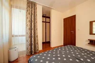 a bedroom with a bed and a window at Гнездото на Гълъба in Ostrets