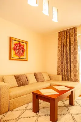 a living room with a couch and a coffee table at Гнездото на Гълъба in Ostrets