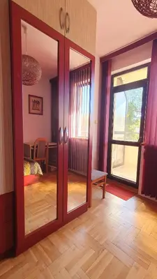a living room with a sliding glass door with a dining room at Malina Apart in Plovdiv