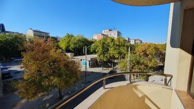 a view of a city from the balcony of a building at Malina Apart in Plovdiv